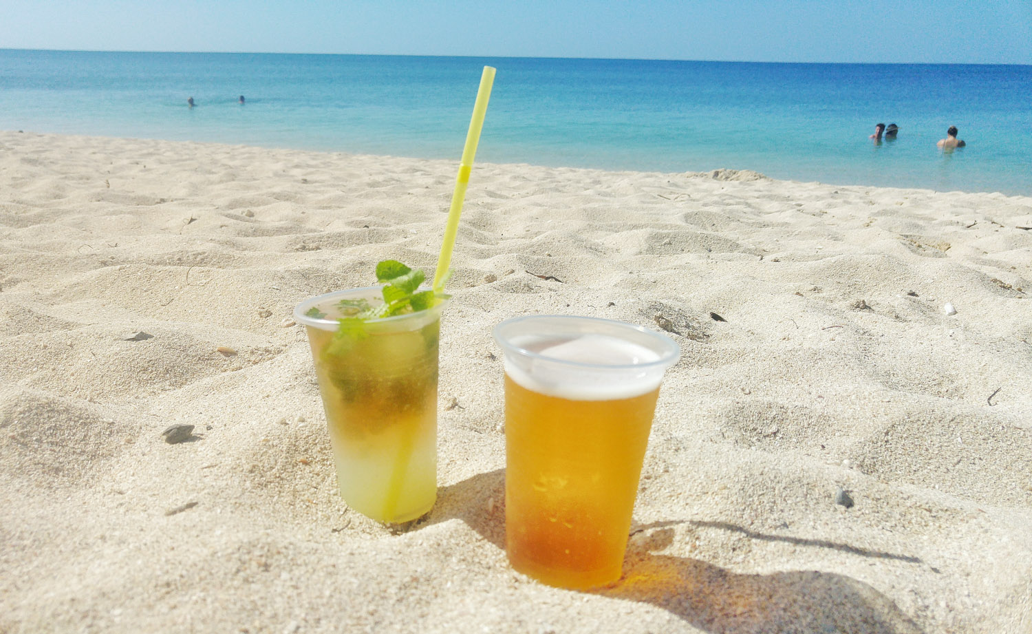 Enjoying a cold beer and mojito on the beach for 1 CUC.