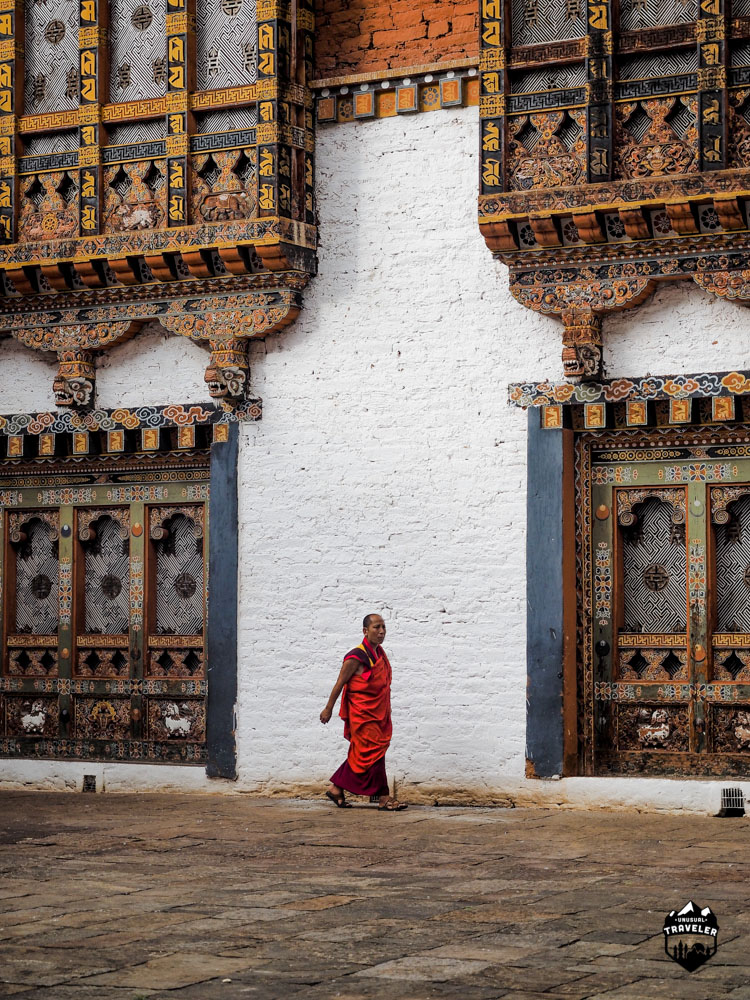 A residential monk walking across the third courtyard