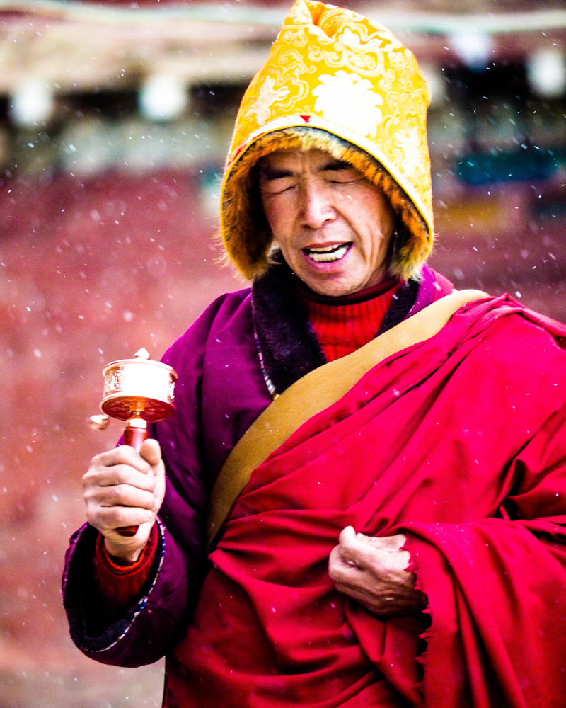 A devoted Buddhist monk waling trough the snow blizzard
