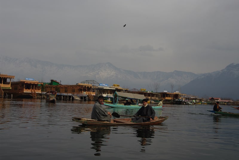 locals padling around dal lake